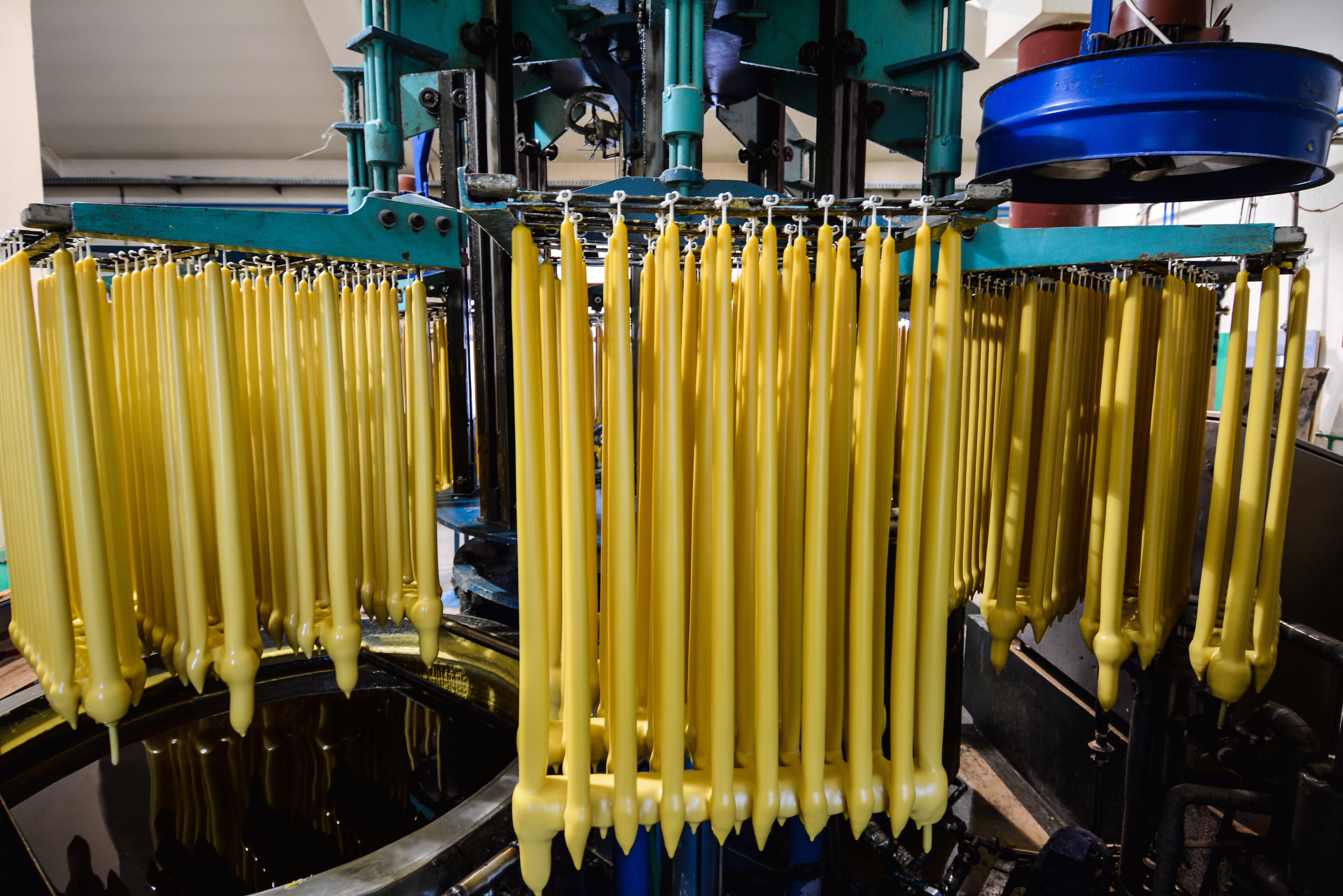 Dipped wax candles drying