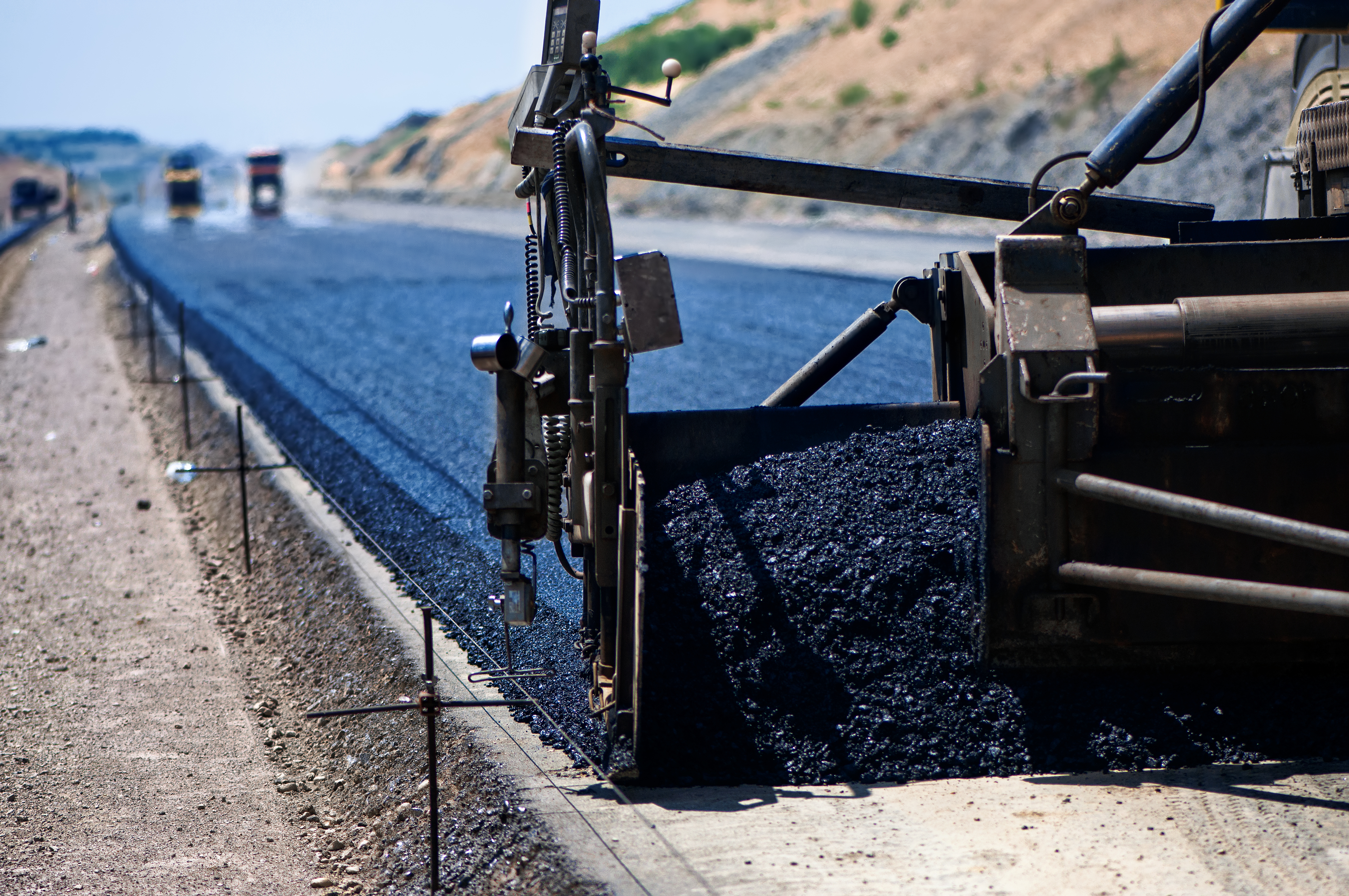 road spreader spreading asphalt