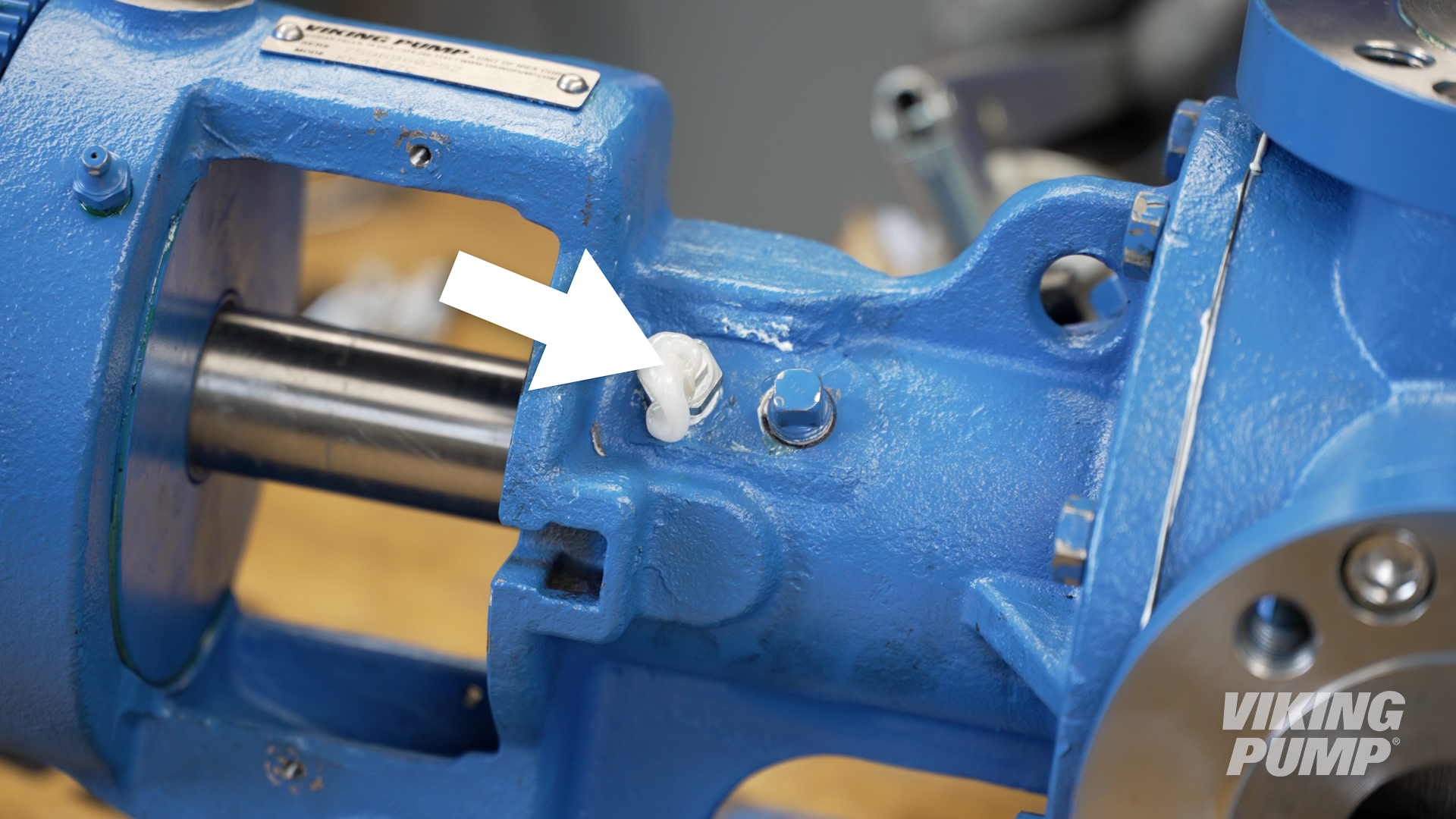 Image of grease exiting a grease relief fitting in the bracket of an internal gear pump with a behind the rotor seal.