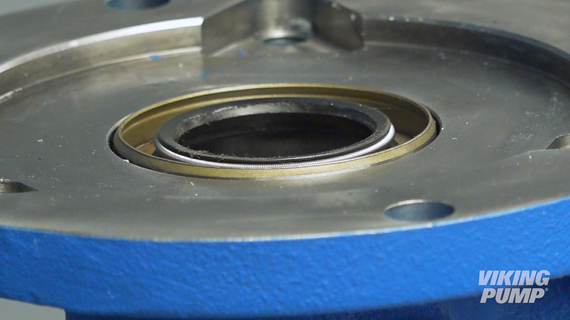 Image showing the direction of a lip seal before being pressed into place in a gear pump.