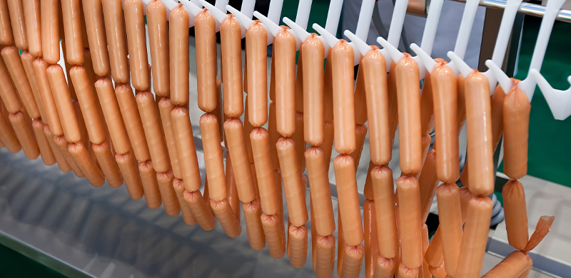 Sausages on a conveyer system