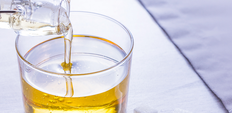 liquid sugar solution being poured into a glass