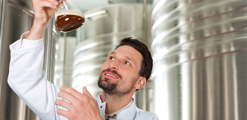 Person swirling yeast in a beeker