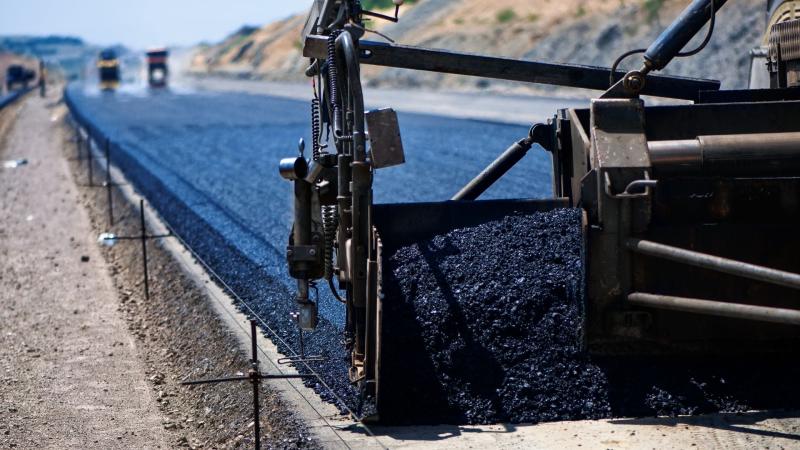 Asphalt being spread onto road