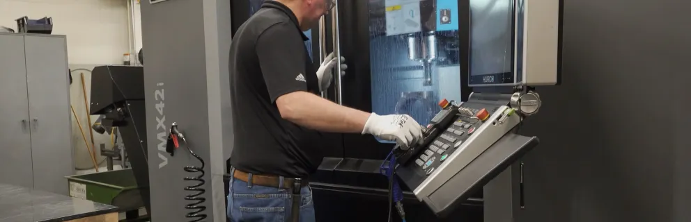product engineering lab worker using vertical machining center