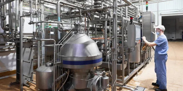 man checking control panel in hygienic facility