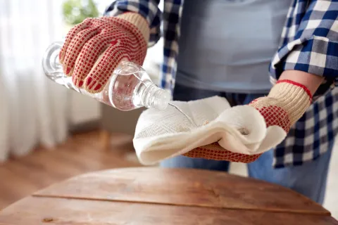 person pouring acetone onto rag