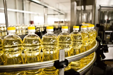 Factory showing cooking oil bottles on a track