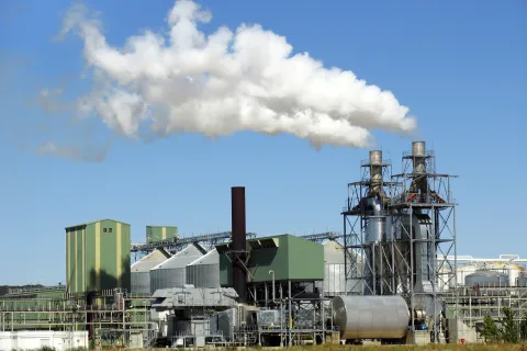 Biofuels factory with smokestacks on a farm