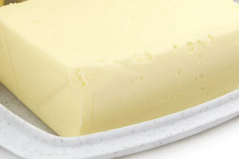 Yellow stick of butter in tray