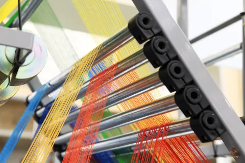 Industrial loom with multi-colored threads