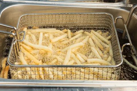 French fries being deep fried in oil