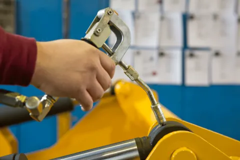 Grease being applied to industrial machine joint