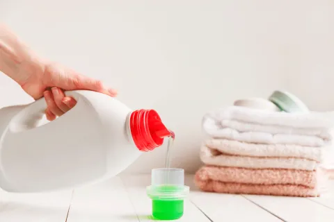 Laundry detergent being poured into a cap