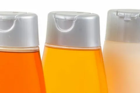 Top third of plastic shampoo bottles